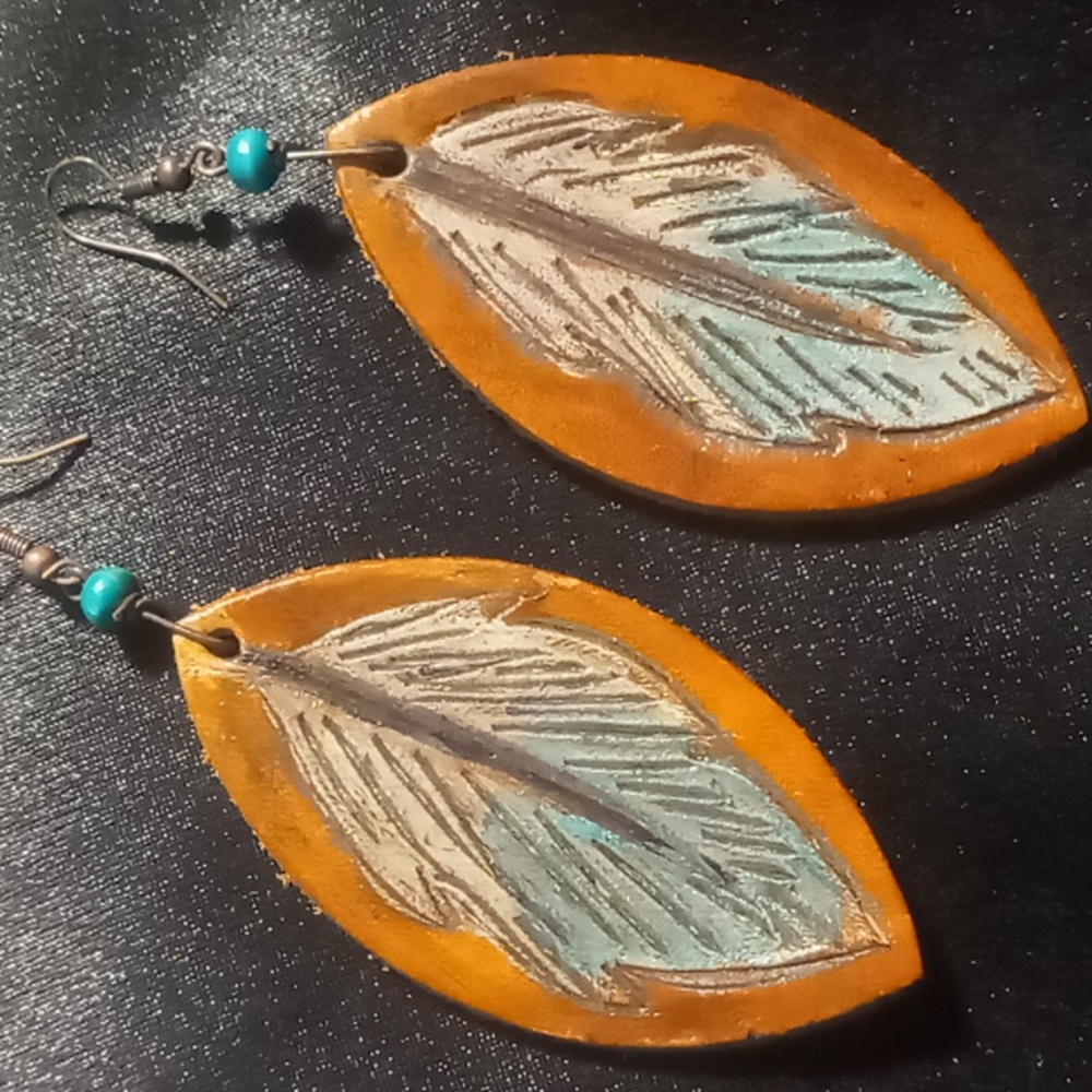 Thick cut hard leather etched & stamped feathers. On copper hooks
